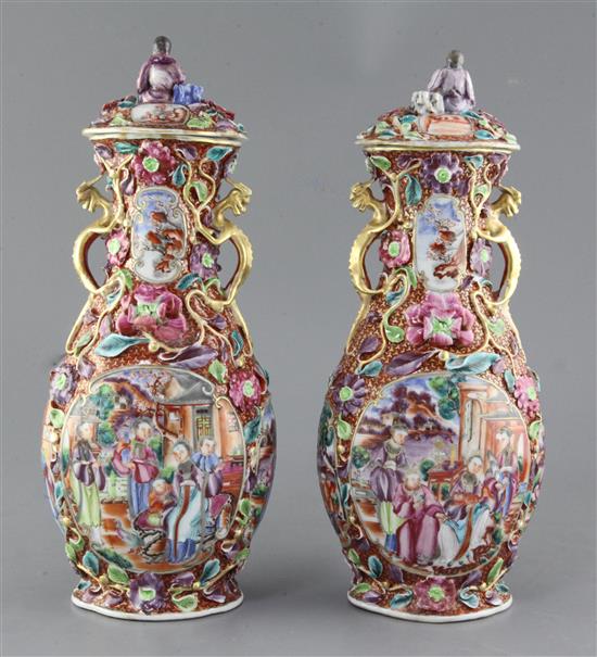 A pair of Chinese famille rose Mandarin vases and covers, Qianlong period, 35.5cm, some restorations